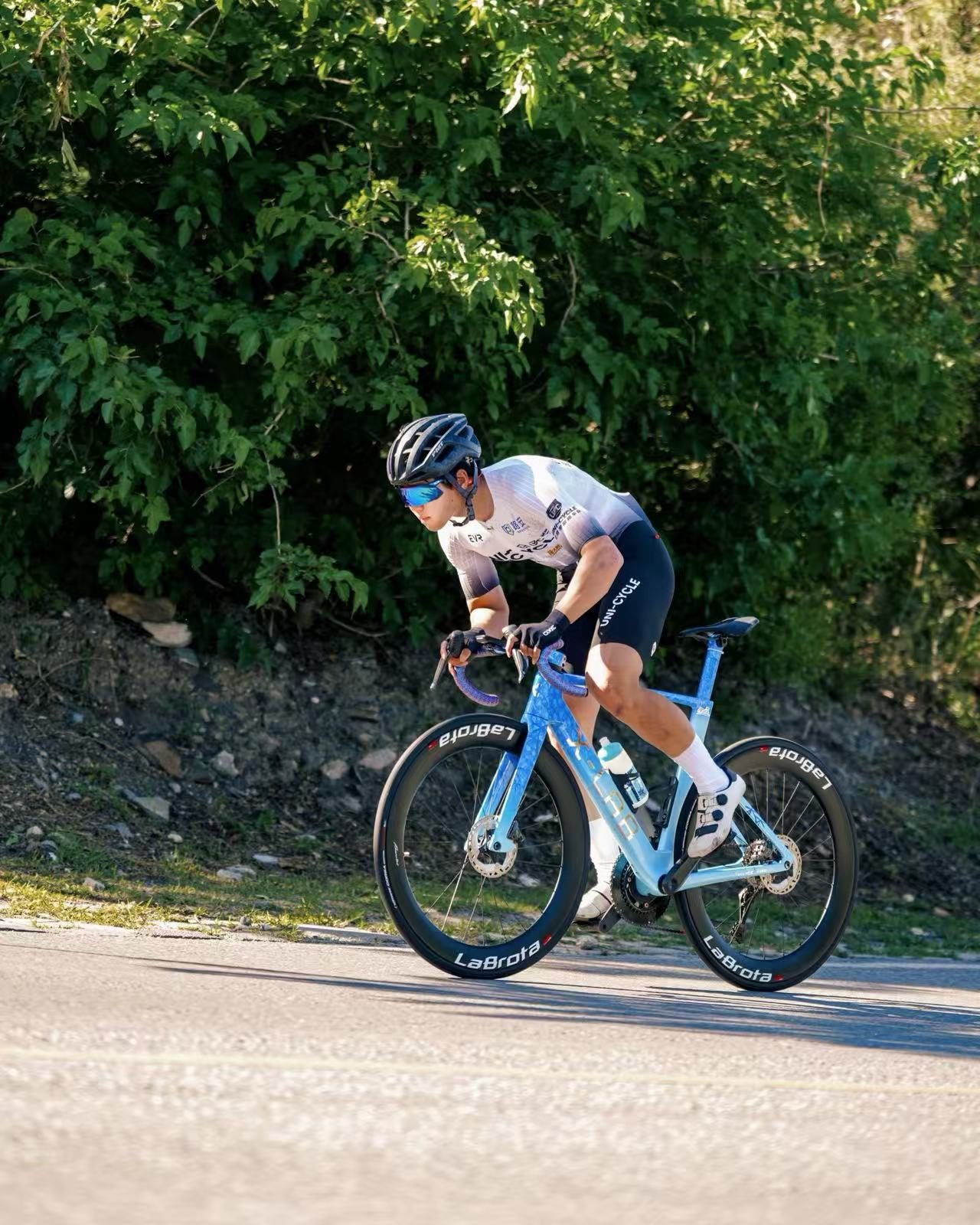 Climbing on blue LaBrota bike