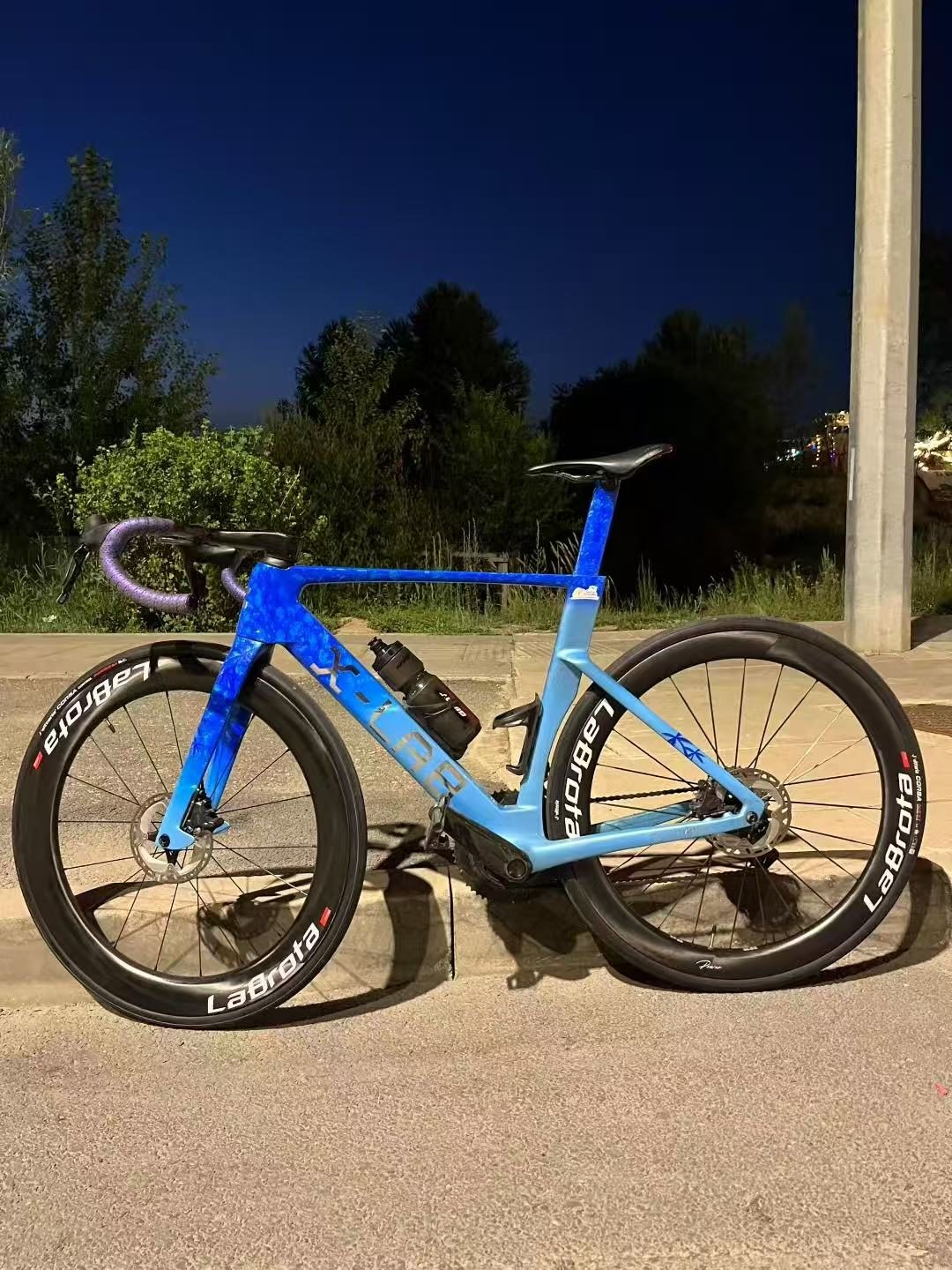 Blue bike night side profile
