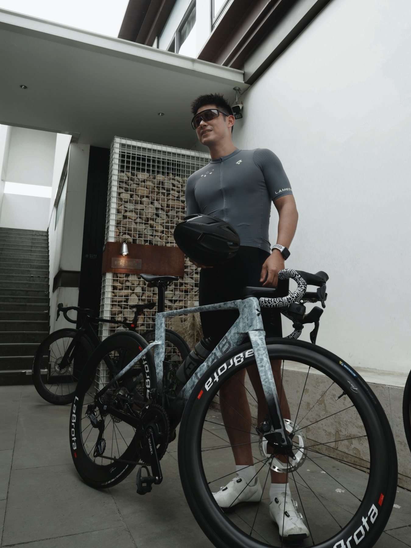 Captain Cola standing with helmet and LaBrota bike