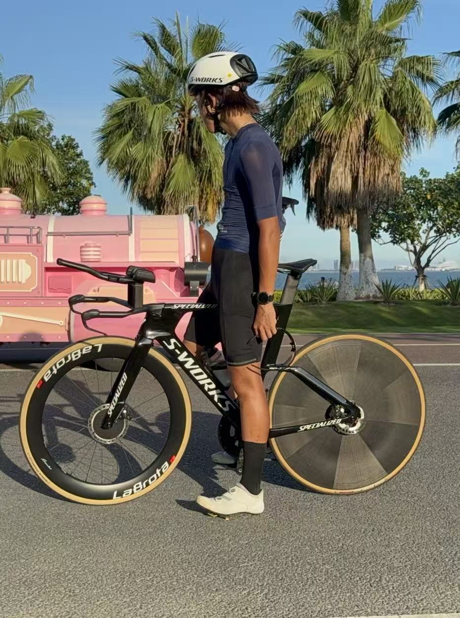 Full side profile of Louis standing beside a black S-Works TT bike with LaBrota front wheel and disc rear wheel